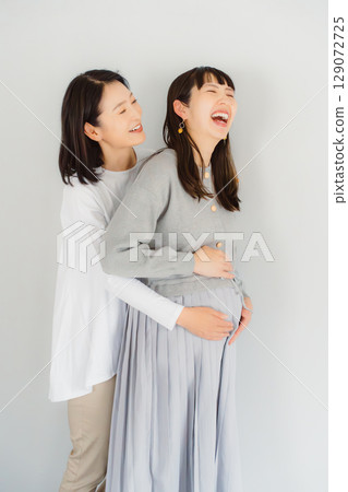 A happy mother and her daughter nearing the end of her pregnancy A happy mother and her daughter nearing the end of her pregnancy 129072725