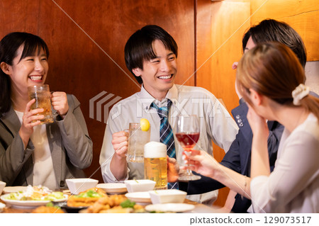 Drinking party: Men and women drinking at an izakaya 129073517