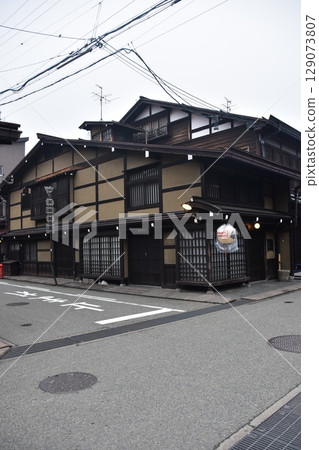 Old townscape of Kamisannomachi, Takayama City, Gifu Prefecture, Japan. Old houses and decorative lanterns that evoke a sense of history. Scenery during the Takayama Festival in Spring. Old townscape of Kamisannomachi, Takayama City, Gifu Prefecture, Japan. Old houses and decorative lanterns that evoke a sense of history. Scenery during the Takayama Festival in Spring. 129073807
