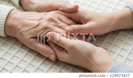 Young Hands Holding Elderly Hands with Care - Ai generated Young Hands Holding Elderly Hands with Care - Ai generated 129073827