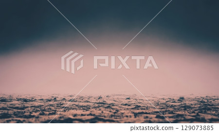 Moody landscape at dusk with fog settling over a textured ground in a serene natural environment 129073885