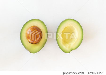 Photo of cut avocado on white background 129074455