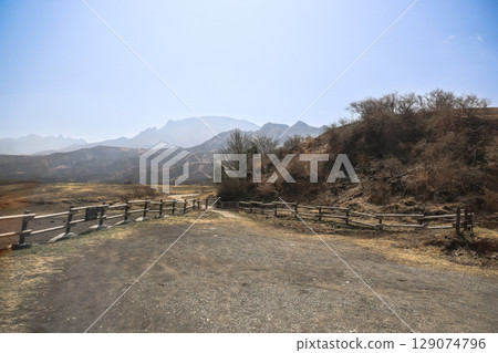March 25 2025 Countryside View With Wooden Fence and Blue Sky Horizon, Japan March 25 2025 Countryside View With Wooden Fence and Blue Sky Horizon, Japan 129074796