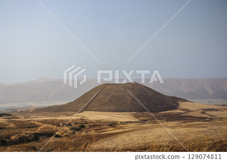 March 25 2025 Brown Hill in Vast Open Landscape with Mountains in the Distance, Japan 129074811