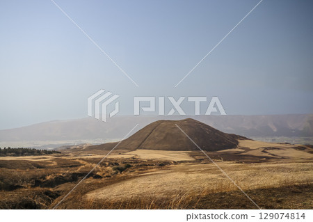 March 25 2025 Brown Hill in Vast Open Landscape with Mountains in the Distance, Japan 129074814