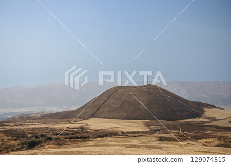 March 25 2025 Brown Hill in Vast Open Landscape with Mountains in the Distance, Japan March 25 2025 Brown Hill in Vast Open Landscape with Mountains in the Distance, Japan 129074815