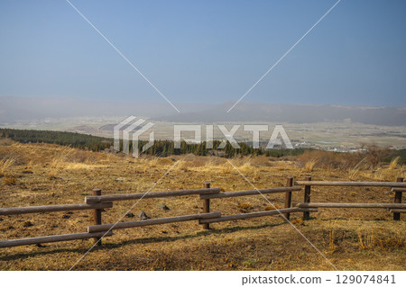March 25 2025 Rustic Wooden Fence Overlooking a Scenic Countryside Landscape, Japan 129074841