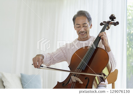 Senior man playing the cello Senior man playing the cello 129076130