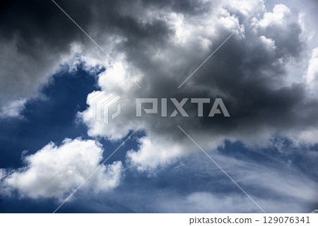 Dramatic dark storm rain clouds black sky background. Dark thunderstorm clouds rainny atmosphere. Meteorology danger windstorm disasters climate. Dark cloudscape storm disaster gloomy gray cloud sky Dramatic dark storm rain clouds black sky background. Dark thunderstorm clouds rainny atmosphere. Meteorology danger windstorm disasters climate. Dark cloudscape storm disaster gloomy gray cloud sky 129076341
