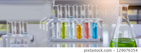 Banner Science chemistry glass tubes object on lab background. Wide Liquid tube biology laboratory chemical fluid scientist object medical glass tubes. Chemistry scientific background with Copy Space 129076354
