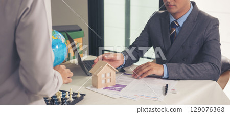 Banner Businessman real estate house agent team businessperson. Manager selling house real estate agent at office desk. Businessman working home insurance mortgage sale apartment with copy space 129076368