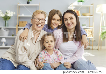 Portrait Of Happy Grandmother And Family Embracing Portrait Of Happy Grandmother And Family Embracing 129076753