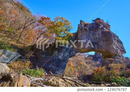 View of the fourth stone gate on the hiking trail of Prefectural Myogi Park in Shimonita Town, Gunma Prefecture in autumn from Stone Gate Square 129076787