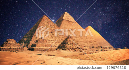 night scene of the castle pyramid in the desert 129076818