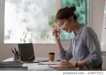 Remote Work. Happy woman brainstorming ideas in home office. 129077251