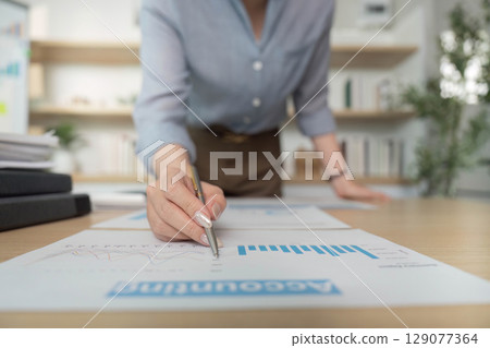 Accountant Reviewing Financial Charts and Graphs Accountant Reviewing Financial Charts and Graphs 129077364