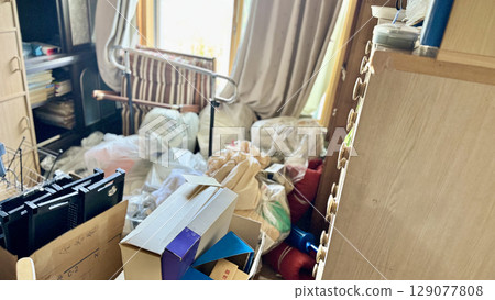 A messy room with garbage bags scattered all over 129077808