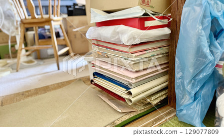 Stacks of albums and a high chair 129077809