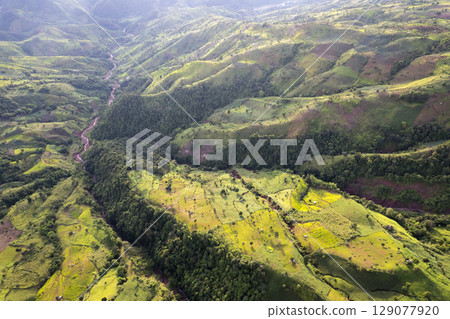 Landscape of Morning Mist with Mountain Layer. mountain ridge and clouds in rural jungle bush forest Landscape of Morning Mist with Mountain Layer. mountain ridge and clouds in rural jungle bush forest 129077920