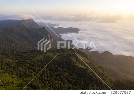 Landscape of Morning Mist with Mountain Layer. mountain ridge and clouds in rural jungle bush forest Landscape of Morning Mist with Mountain Layer. mountain ridge and clouds in rural jungle bush forest 129077927