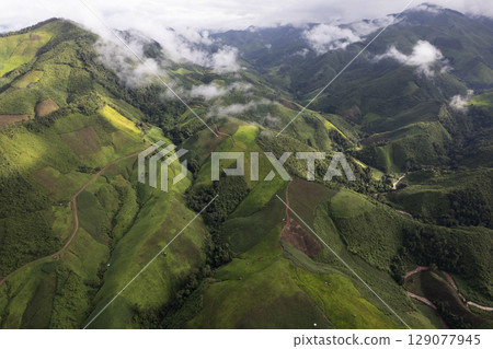 Landscape of Morning Mist with Mountain Layer. mountain ridge and clouds in rural jungle bush forest 129077945