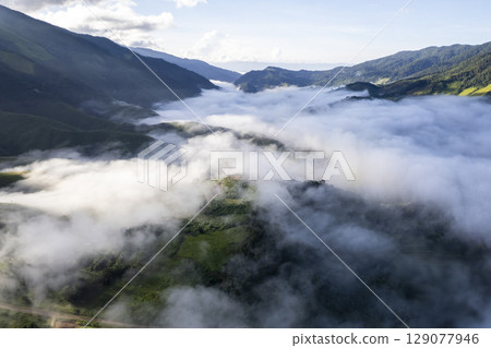 Landscape of Morning Mist with Mountain Layer. mountain ridge and clouds in rural jungle bush forest 129077946