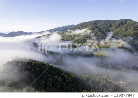 Landscape of Morning Mist with Mountain Layer. mountain ridge and clouds in rural jungle bush forest 129077947