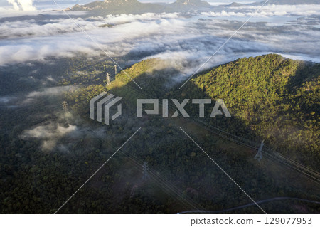 Landscape of Morning Mist with Mountain Layer. mountain ridge and clouds in rural jungle bush forest 129077953