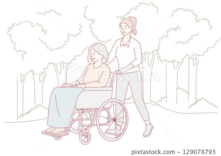 A caregiver assists an elderly woman in her wheelchair outdoors, fostering a joyful atmosphere 129078793