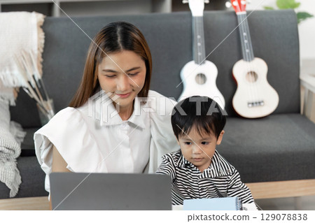 Mother and Child Collaborating on Laptop for Learning Mother and Child Collaborating on Laptop for Learning 129078838