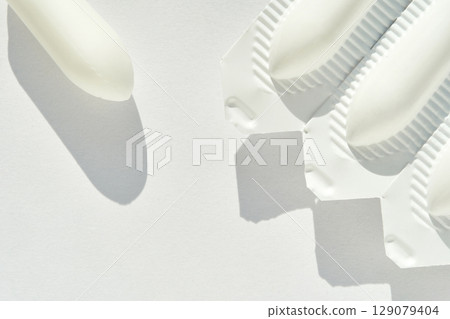 Medical suppository package flat lay on white background with shadows 129079404