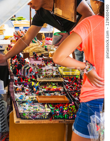 Miyagawa Morning Market: Tourists purchasing Hida dolls "Sarubobo" 129080480