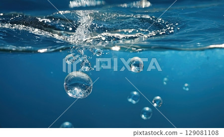 Underwater bubbles rise through blue water creating rippling effects and a sense of tranquility Underwater bubbles rise through blue water creating rippling effects and a sense of tranquility 129081108