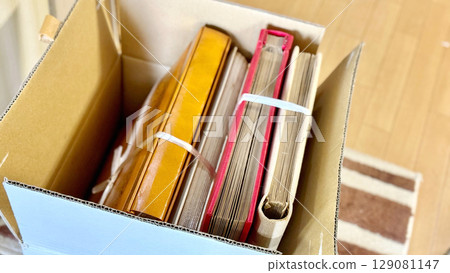 Many albums in a cardboard box 129081147