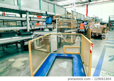 packing line in a logistics warehouse. conveyor belt in a modern production line 129081804