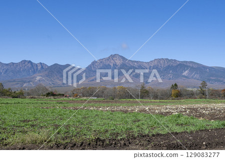 A landscape painting of the majestic Yatsugatake Mountains seen from a ranch in Nobeyama 129083277