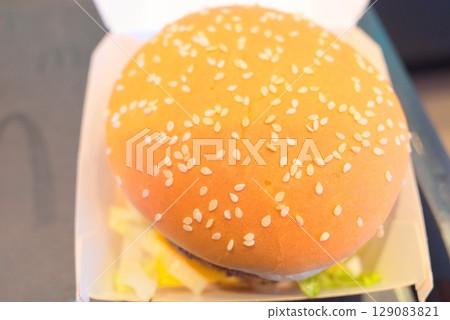 A hearty double patty hamburger served on a sesame seed bun A hearty double patty hamburger served on a sesame seed bun 129083821