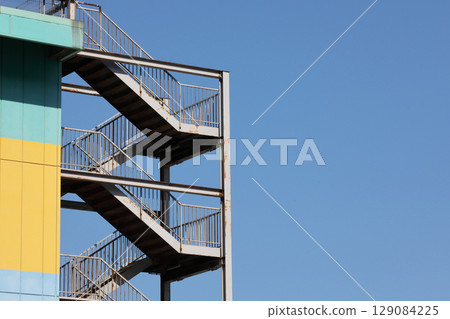 Outdoor stairs, emergency stairs, blue sky, colorful, parking lot 129084225