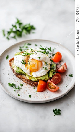 A freshly made avocado toast with poached egg. 129084733