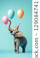 Elephant with party hat and balloons on solid background. 129084741