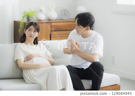 pregnant woman in the living room pregnant woman in the living room 129084945