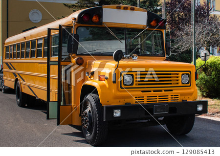 A classic yellow American school bus parked in scenic nature. Back to school 129085413