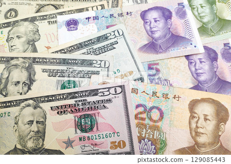Stack of US Dollar and Chinese Renminbi Stack of US Dollar and Chinese Renminbi 129085443