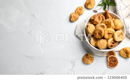 Dried figs in bowl on marble background Dried figs in bowl on marble background 129086408
