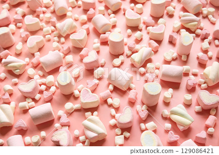 Confectionery and sweeties varieties background: light pink and white marshmallows, sugar confetti, bonbon and candies, selective focus Confectionery and sweeties varieties background: light pink and white marshmallows, sugar confetti, bonbon and candies, selective focus 129086421