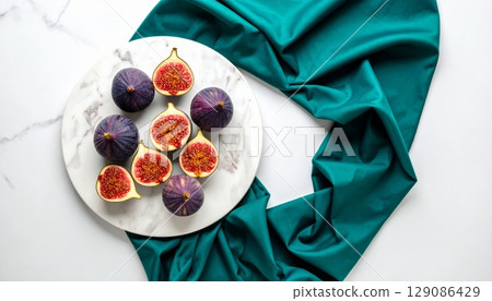 Fresh figs on marble plate and teal fabric 129086429