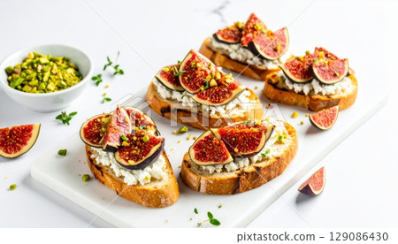 Delicious toast with figs and cream cheese on top, on marble table 129086430