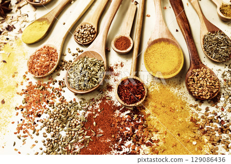 Colorful mix of herb and spice varieties: curry and coriander, turmeric and cumin, paprika and pepper, mustard and salt, cardamon and oregano and saffron. Selective focus, shallow DOF Colorful mix of herb and spice varieties: curry and coriander, turmeric and cumin, paprika and pepper, mustard and salt, cardamon and oregano and saffron. Selective focus, shallow DOF 129086436