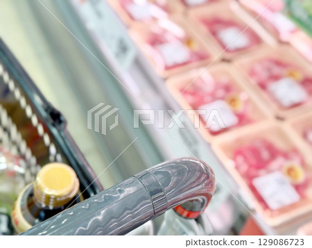 Sauces in a shopping cart next to the meat section Sauces in a shopping cart next to the meat section 129086723