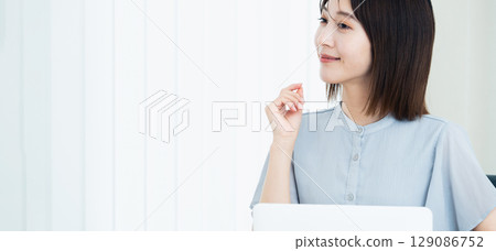 Woman using a laptop Woman using a laptop 129086752